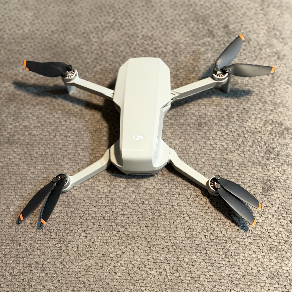DJI Light Gray Drone with Orange Accents